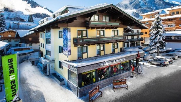 A ski resort building with a shop named 'Berg Amis-Kloster' and a 'Bike U2' sign. - Hotel Heli's (Hinterglemm)