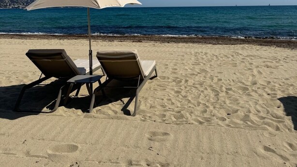 Two beach chairs and a beach umbrella on a sandy beach with a clear blue sky and calm sea. - Luxury Villa for 12 Guests with Heated Pool in St. Maxime, La Nartelle Private Estate (Sainte-Maxime)