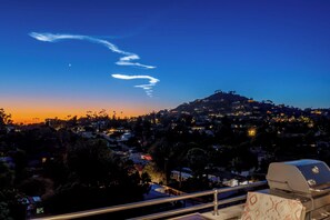 A nighttime view of a cityscape with a hilltop and a grill in the foreground. - Panoramic Estate As Seen on 90 Day Fiancé (La Mesa)