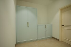 A room with a light blue wardrobe, a door, and a tiled floor. - Kaayanaat Luxury Villa Amritsar Airport (Amritsar)