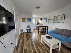 A modern living space with a kitchen, dining area, and a sofa. - Cozy Place Near the Design District | Free parking (Miami)