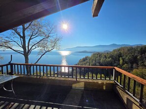 A balcony with a view of a lake and mountains.