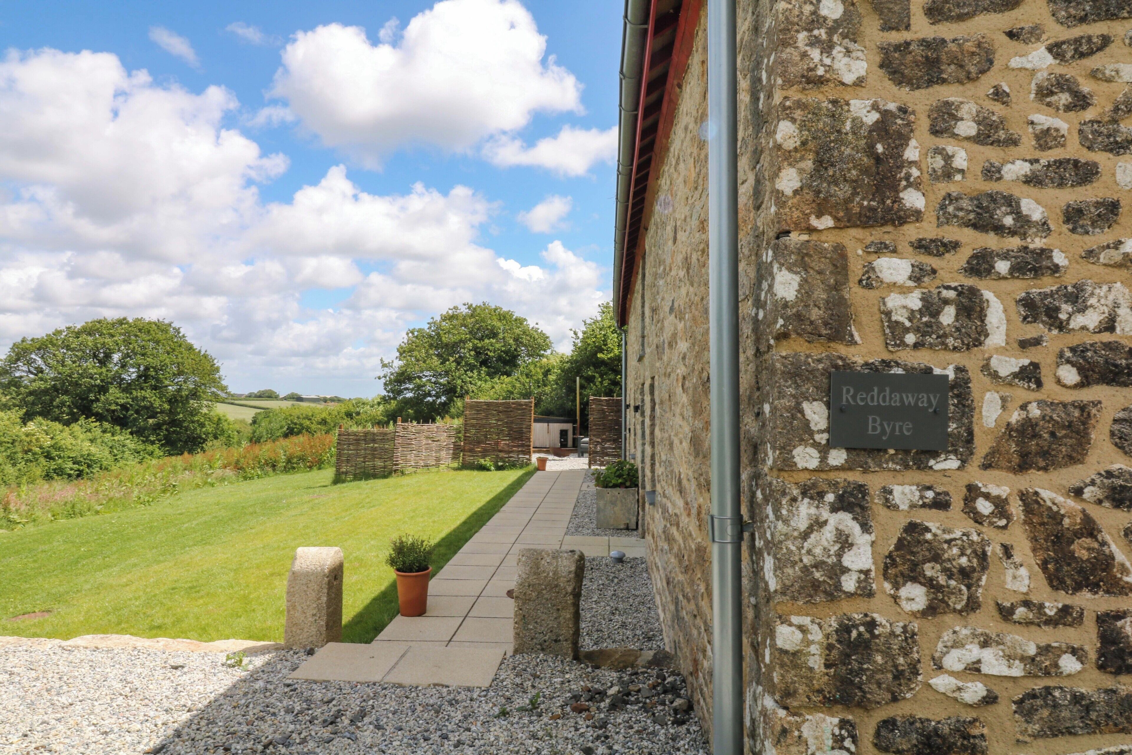 A stone building with a sign reading 'Reddaway Byre.'