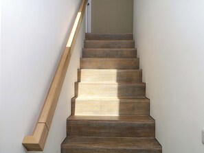 A wooden staircase with a handrail, leading to a landing. - Reddaway Byre (Okehampton)