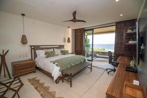 Ein Schlafzimmer mit einem Bett, Nachttischen aus Holz, einer Bank, einem Schreibtisch und einem Stuhl.