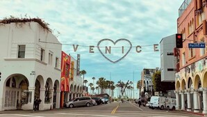A street view with a prominent sign reading 'VENTICE' and a traffic light. - NEW! Boutique Coastal home Steps from the Beach (Marina del Rey)