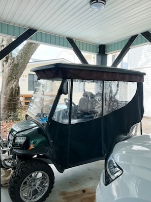 A covered parking area with a vehicle and a tree. - Ocean Views, 5 min walk to Beach, Waterpark, Arcade, Store ~ 5 bd/3; Sleeps 10 (Myrtle Beach)