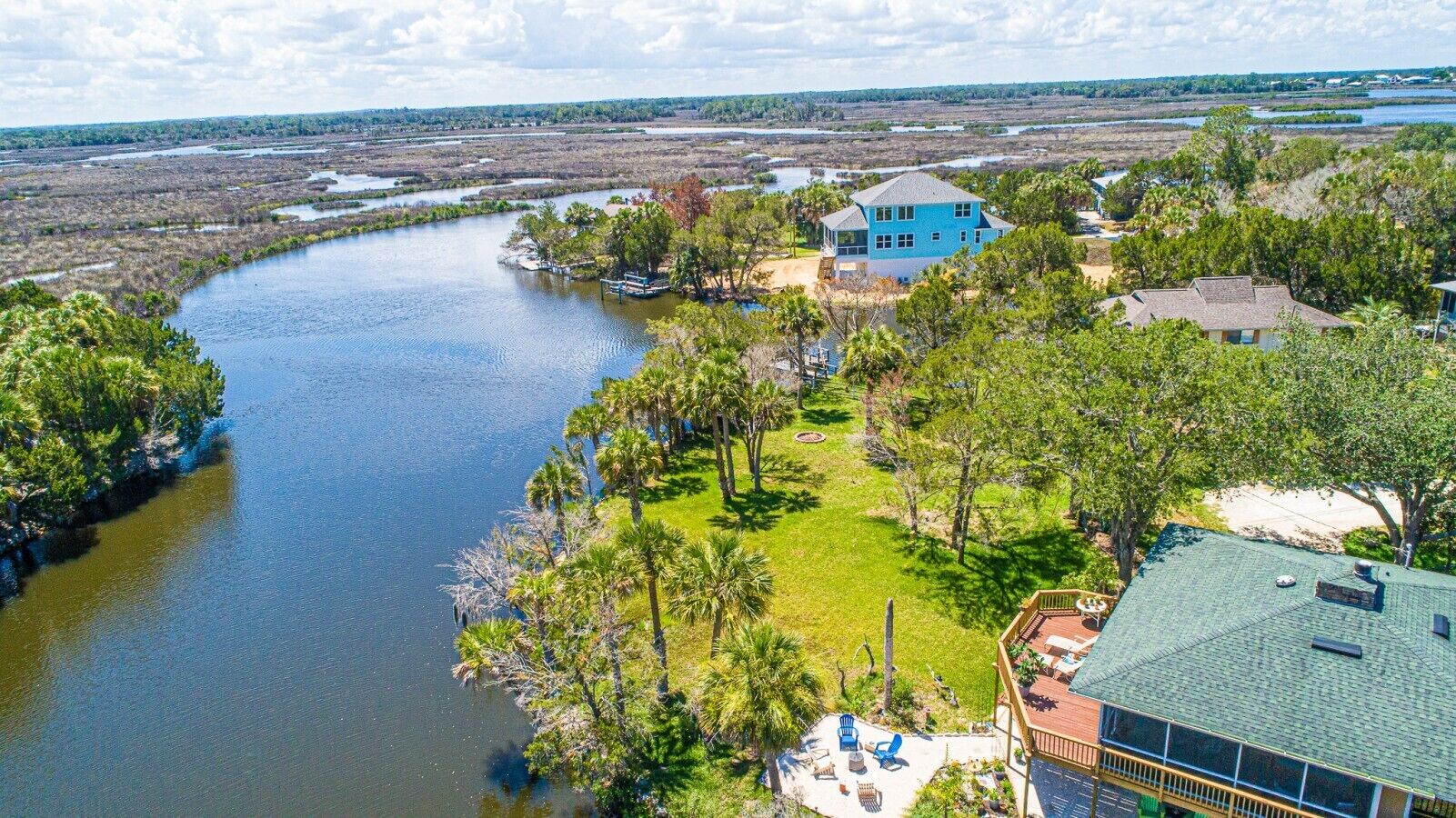 Exterior of home with water views, fire pit, water views, & dock