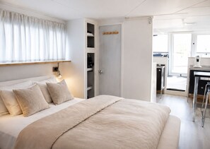 Une chambre à coucher avec un lit, une table de chevet et une armoire.