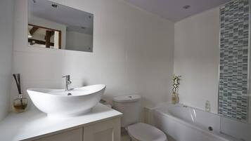 Combined shower/bathtub, deep-soaking bathtub, hair dryer, towels