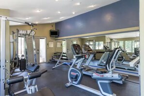 A gym with various exercise equipment, including treadmills and weight machines. - Cozy 1-bed A/C condo in beautiful Phoenix with Pool, Golf Simulator and Gated (Phoenix)