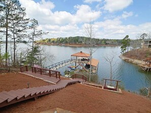 A lakeside property with a dock, wooden deck, and a gazebo. - Spectacular 4-bedroom house on beautiful Lake Wedowee (Wedowee)