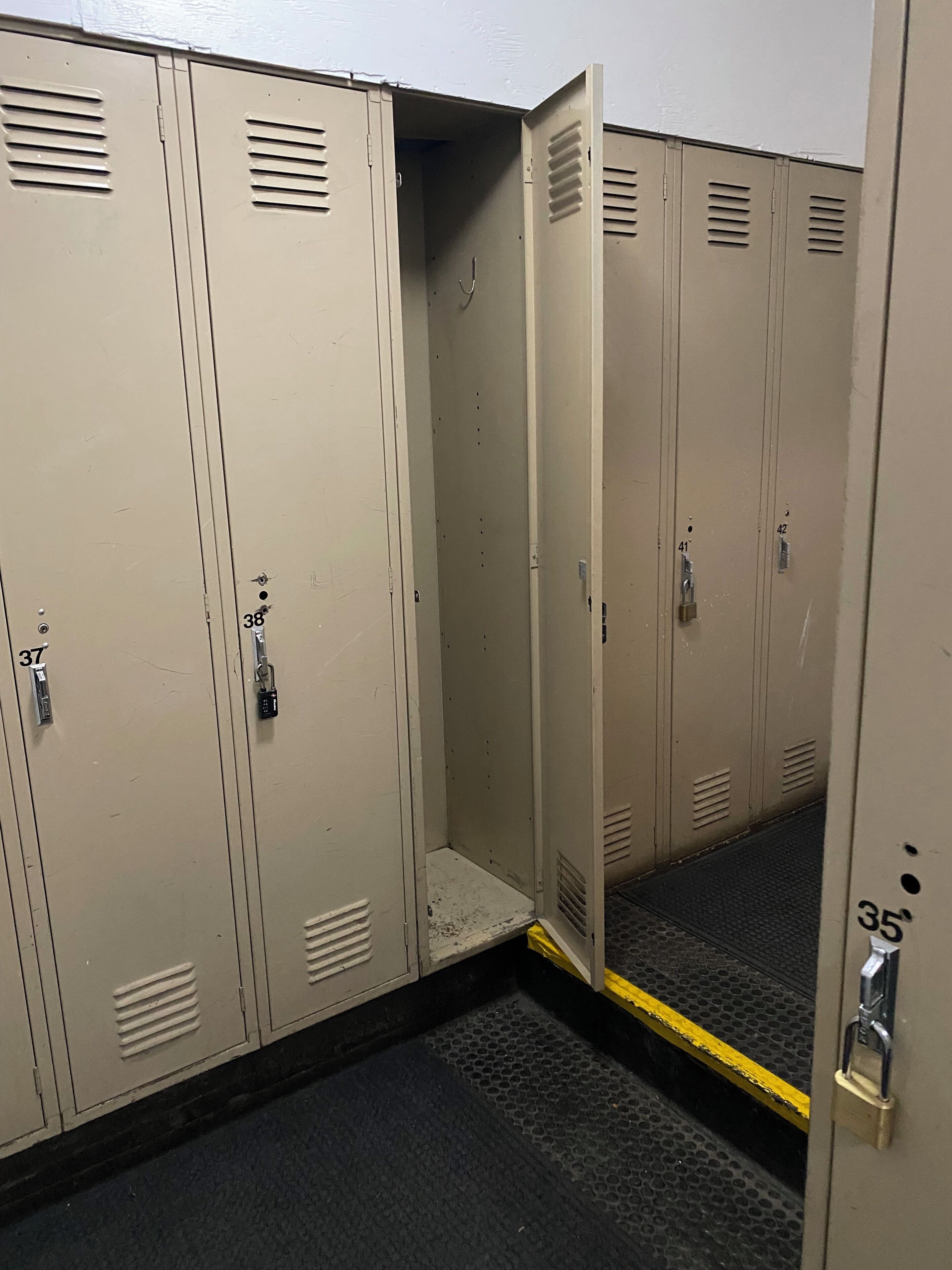 A row of beige lockers with numbers 37, 38, 35, and 42 visible.