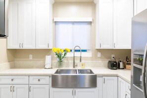 A kitchen with white cabinets, a stainless steel sink, a window with a view, and a toaster on the counter. - #D 1-level, 2Bd, 1block to Beach, Esplanade, Shops (Redondo Beach)