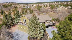 A residential property with a two-story house, a covered patio, and a driveway. - Fabulous 5-bedroom house in Colorado Springs, perfect for relaxing (Colorado Springs)