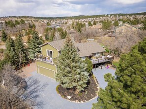 A residential property with a two-story house, a covered patio, and a driveway. - Fabulous 5-bedroom house in Colorado Springs, perfect for relaxing (Colorado Springs)