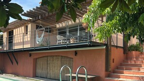 A swimming pool with a wooden deck, a covered outdoor seating area, and a staircase leading to a second level. - Villa with a Pool Nestled in the Esterel Mountains, 10 Minutes from the Beaches of Mandelieu and Cannes (Fréjus)