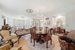 A dining room with a round table, chairs, and a chandelier. - The Ultimate Historic Vibe: Queen Anne Victorian Meets Modern Indie Style Just Steps from The Courthouse Square (Prescott)