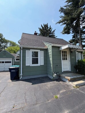 A single-story house with a green exterior, white trim, and a grey roof. - 3 bedroom Updated Fully fenced yard (Rochester)
