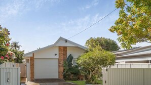 A residential house with a garage, a driveway, and a fenced yard. - Coastal Comfort with a Private Spa Retreat (Margate)