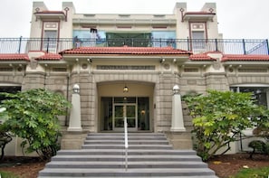A building with a sign reading 'CENTRALIA SQUARE' at the entrance, featuring a grand staircase, columns, and a balcony with railings.