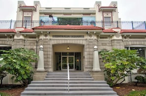 A building with a sign reading 'CENTRALIA SQUARE' at the entrance, featuring a grand staircase, columns, and a balcony with railings.