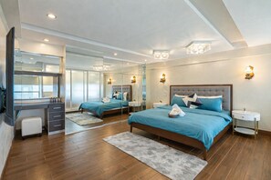 A modern hotel room with a large bed, a desk, and a mirror. - The Cebu Skyline Penthouse Romantic Getaway with Pool, King size Bed, 2 BR (Cebu City)