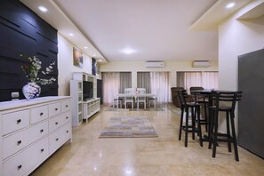 A modern kitchen with a dining area, white cabinetry, and a decorative vase. - 2 BR Apt,New Cairo, in small villa guarded 24/7.Walking distance to all you need (Cairo Governorate)
