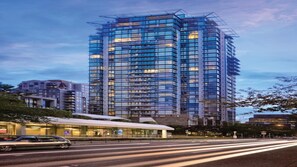 A high-rise building with a modern glass facade, surrounded by other buildings. - Banff National Park Escape Near Downtown & Adventure (Vancouver)
