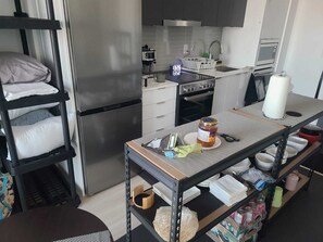 A compact kitchen with a refrigerator, stove, microwave, and sink. - Modern Apartment You Can Enjoy in Heart of Markham 20 mins to Toronto or Airport (Markham)