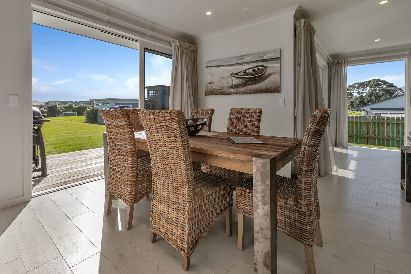 Dining area with seating for 6, opening directly onto the deck with a BBQ.