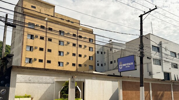 Un hotel de diverses plantes amb un cartell ben visible que diu 'Imperio Hotel'.