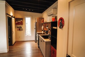 A modern kitchen with wooden flooring, a built-in oven, and a sink. - Marion Cabin private pool, pickleball, park, walking paths, and put-put golf (Marion)
