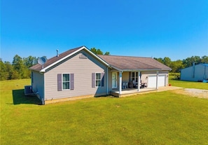 A single-story house with a covered porch and a garage.