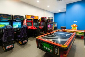 A gaming arcade with multiple arcade machines and a pool table. - ESJ Towers Studio- Beach Access (isla verde)