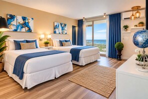 A hotel room with two beds, a large window with a view, artwork on the walls, and a globe on a table. - ESJ Towers Studio Isla Verde with Queen Beds (isla verde)