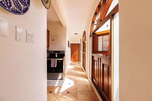 Bright and welcoming with traditional wooden accents and natural light streaming through charming arched windows. - Old San Juan 2 BR Apt with Queen Beds and Sofabeds (SanJuan)