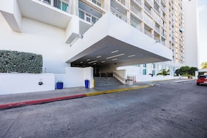 Stylish and well-maintained building entrance with easy access, modern design, and welcoming ambiance—your gateway to a relaxing stay in Isla Verde. - Isla Verde ESJ Towers Studio Apt with Queen Beds (Avenida Isla)
