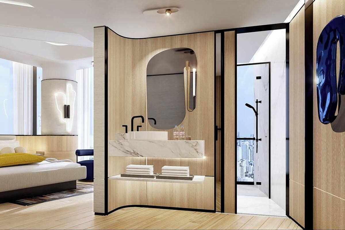 Ein modernes Hotelzimmer mit Bett, Badezimmer mit Spiegel und Blick auf die Stadt.