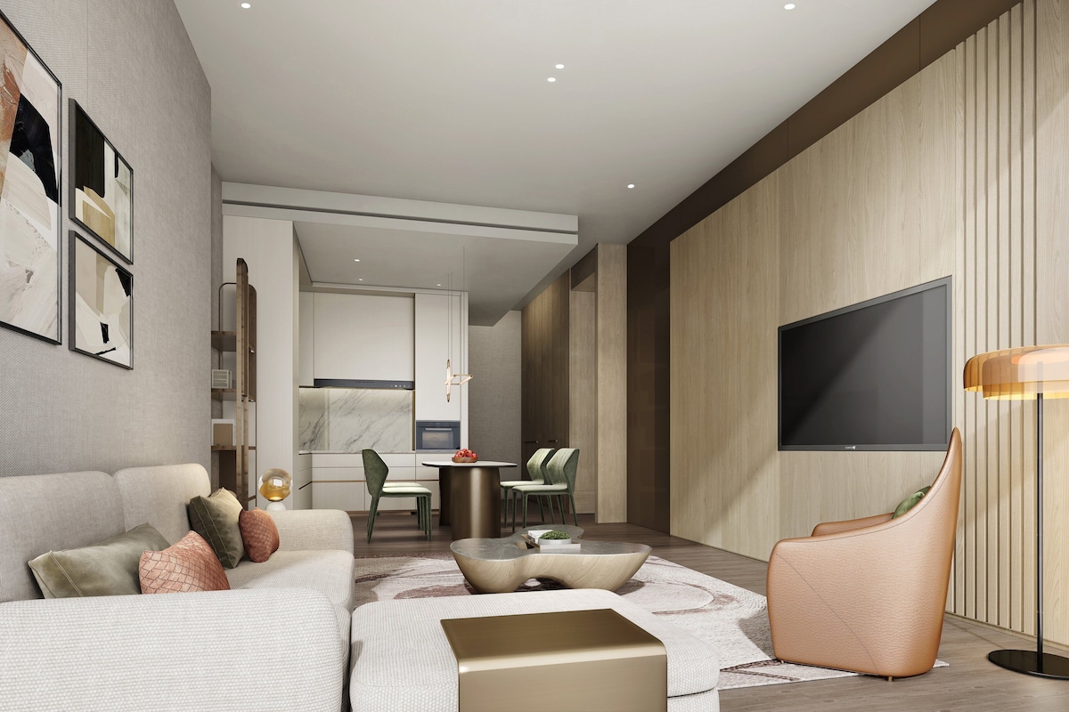 A modern living room with a sofa, coffee table, and a TV.