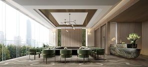 A modern dining area with a long table, green chairs, and a city view. - Intercontinental Taipei by IHG (Taipei)