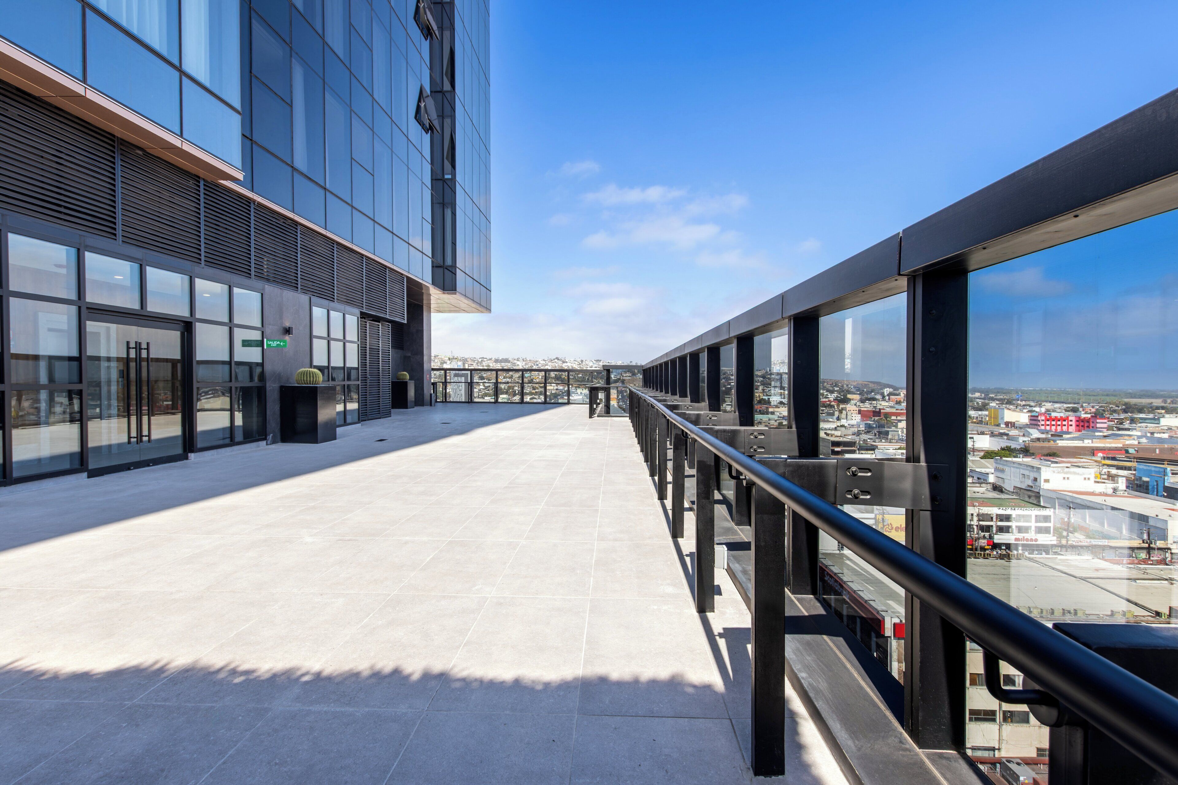 A modern building with large windows and a clear view of the cityscape.