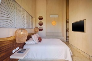 A bedroom with a bed, bedside table, wall-mounted TV, and decorative wall art.