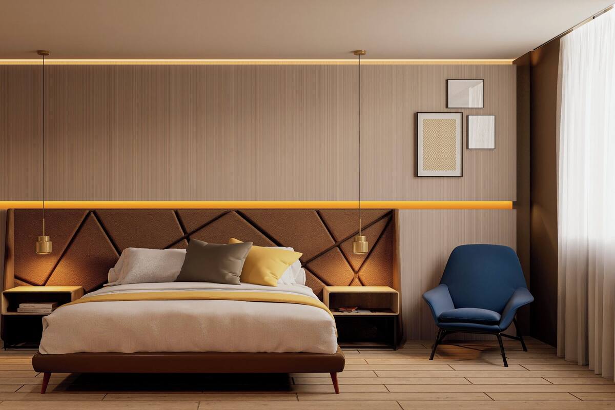 A modern bedroom with a bed, bedside tables, a chair, and wall-mounted lights.