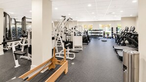 A gym with various exercise machines, treadmills, and dumbbells. - The King & Bear Luxury Studio Retreat (St. Augustine)