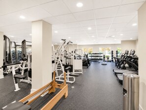 A gym with various exercise machines, treadmills, and dumbbells. - The King & Bear Luxury Studio Retreat (St. Augustine)