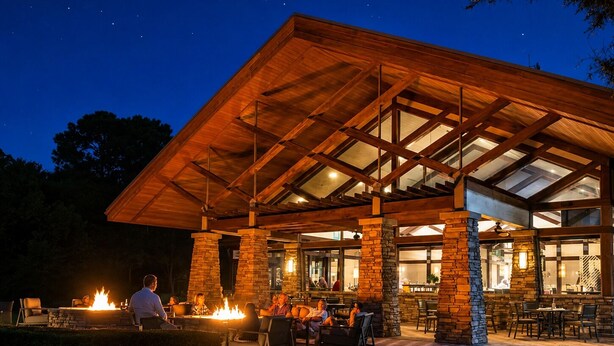 A covered outdoor seating area with stone pillars, a fire feature, and a view of the interior. - The King & Bear Luxury Studio Retreat (St. Augustine)