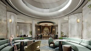 A modern hotel lobby with curved ceilings, seating areas, and a central bar. - The Quchaninner Liyang, Autograph Collection (Changzhou)