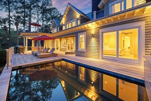 A modern house with a swimming pool, outdoor seating, and large windows. - AMAZING Marsh-view Kiawah Island home with 5 BDs, private pool! (Kiawah Island)
