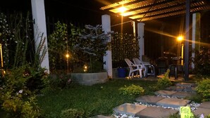 An outdoor patio area with stone pathways, potted plants, and outdoor furniture. - 3-bedroom house in amazing Darién with cool AC breeze (Darién)